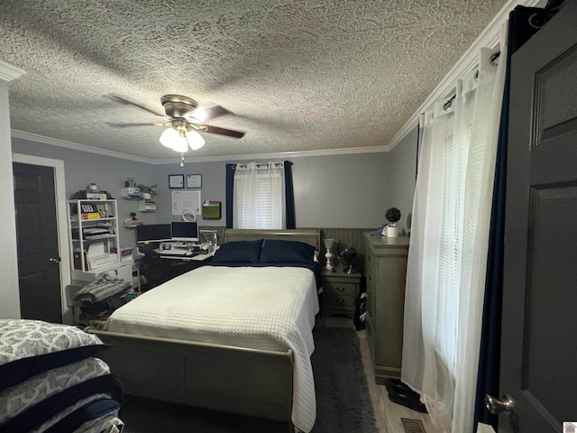 bedroom with ceiling fan, crown molding, and a textured ceiling