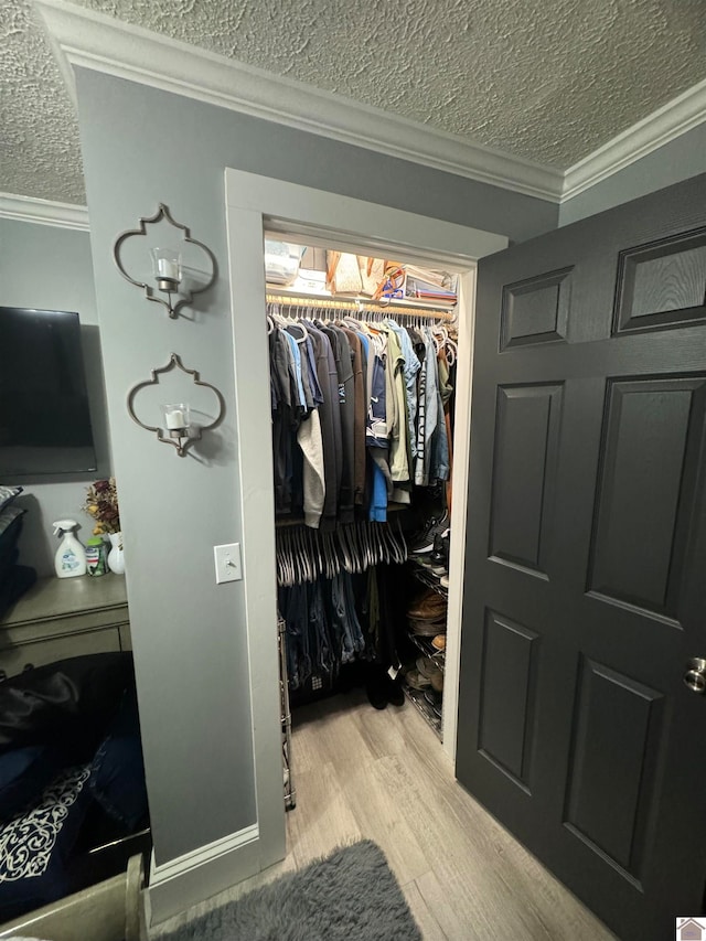 walk in closet featuring light hardwood / wood-style floors