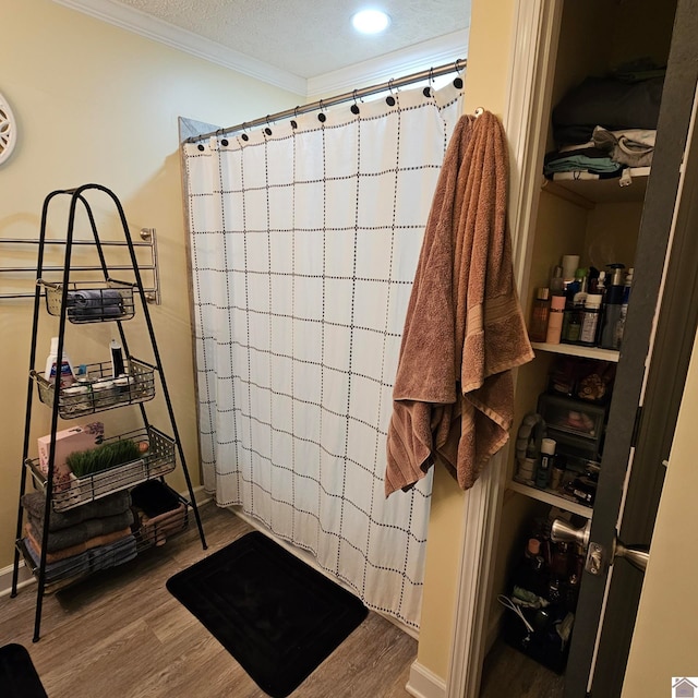 bathroom featuring hardwood / wood-style floors and ornamental molding