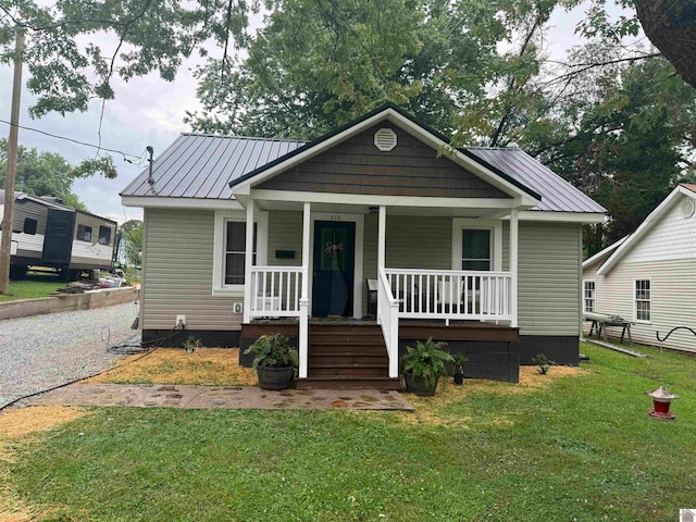 bungalow with a porch and a front lawn