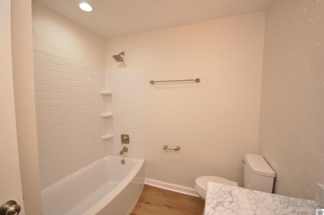 bathroom with wood-type flooring,  shower combination, and toilet