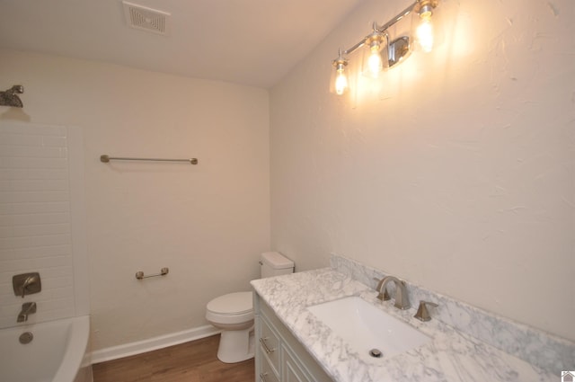 full bathroom with vanity, shower / washtub combination, hardwood / wood-style floors, and toilet