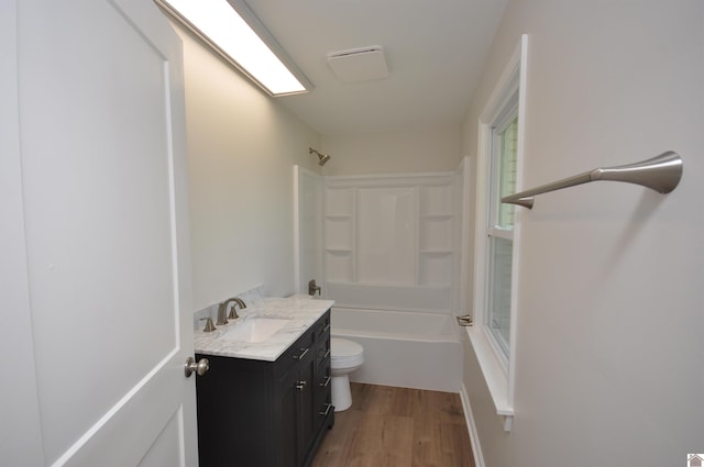 full bathroom featuring vanity, wood-type flooring, shower / washtub combination, and toilet