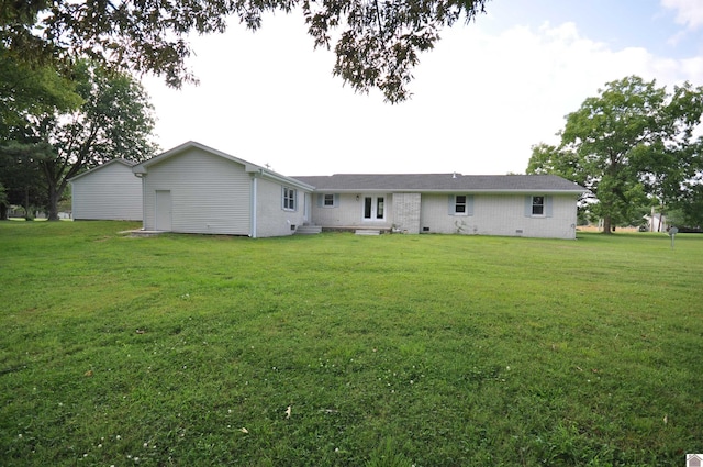 rear view of property with a yard