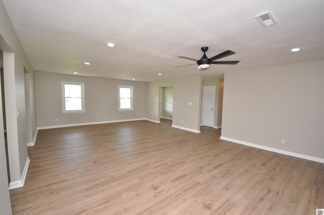 unfurnished room with ceiling fan and light wood-type flooring