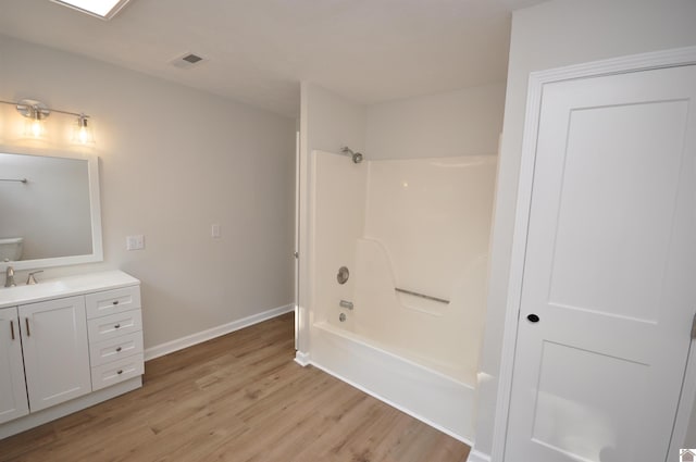 bathroom featuring shower / bathing tub combination, vanity, and wood-type flooring