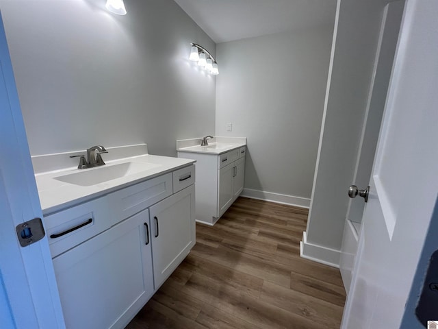 bathroom featuring double sink vanity, hardwood / wood-style flooring, and bathtub / shower combination