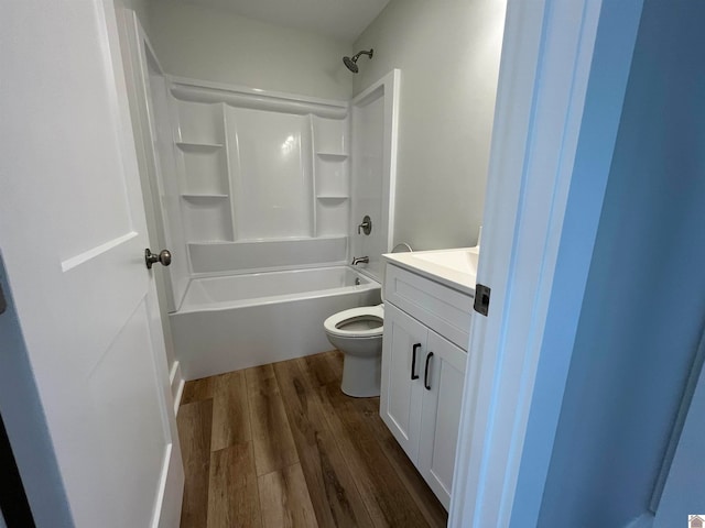 full bathroom with toilet, hardwood / wood-style flooring, shower / bathtub combination, and vanity