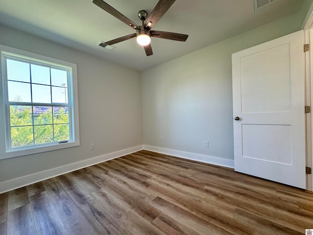 spare room with hardwood / wood-style flooring and ceiling fan