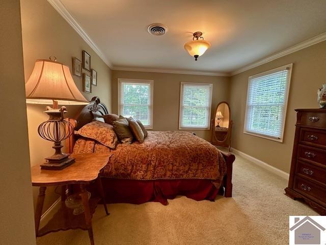 bedroom with baseboards, visible vents, ornamental molding, and light colored carpet