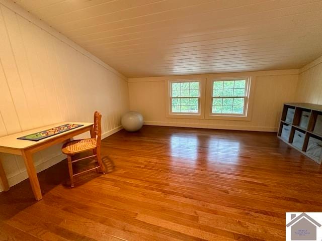 living area featuring hardwood / wood-style flooring and crown molding