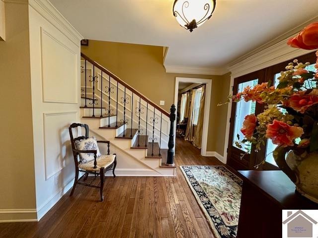 entryway featuring crown molding and hardwood / wood-style floors