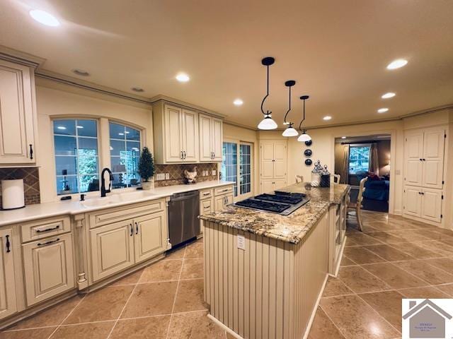 kitchen with tasteful backsplash, stainless steel appliances, sink, light tile patterned floors, and a center island