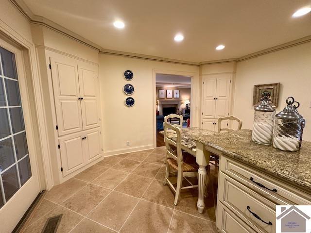 office space with recessed lighting, light tile patterned flooring, crown molding, and visible vents