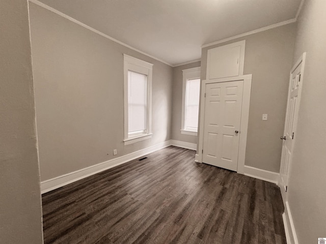 interior space with dark wood-type flooring and ornamental molding