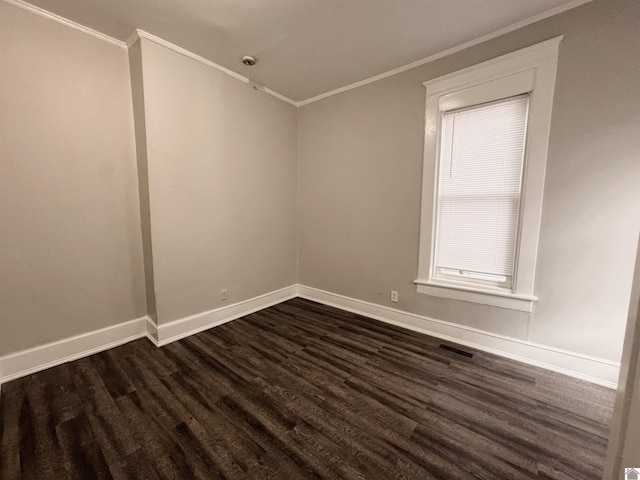 empty room featuring crown molding and dark hardwood / wood-style floors