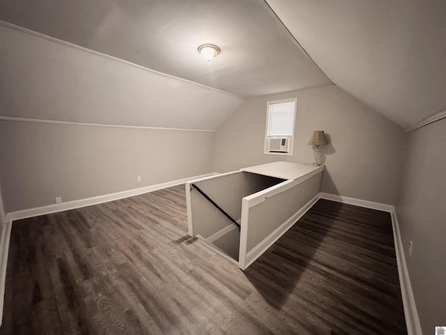 bonus room with lofted ceiling and dark wood-type flooring