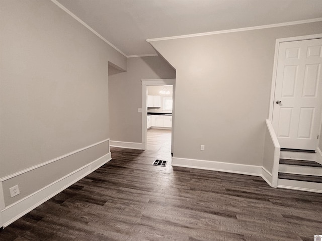 empty room featuring crown molding and dark hardwood / wood-style floors