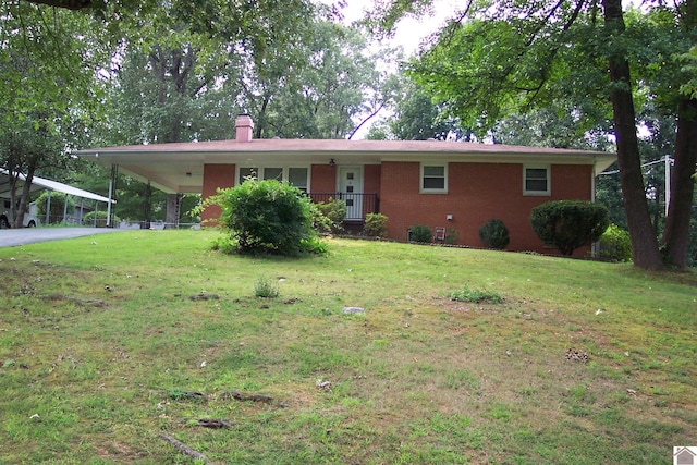 ranch-style house featuring a carport and a front lawn