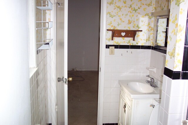 bathroom with tile walls and vanity