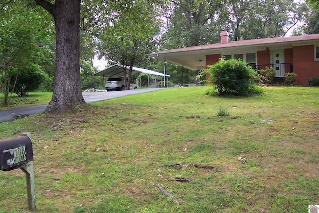 view of yard with a carport and covered porch