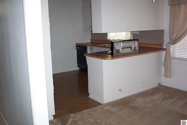 kitchen featuring black dishwasher, dark carpet, and kitchen peninsula