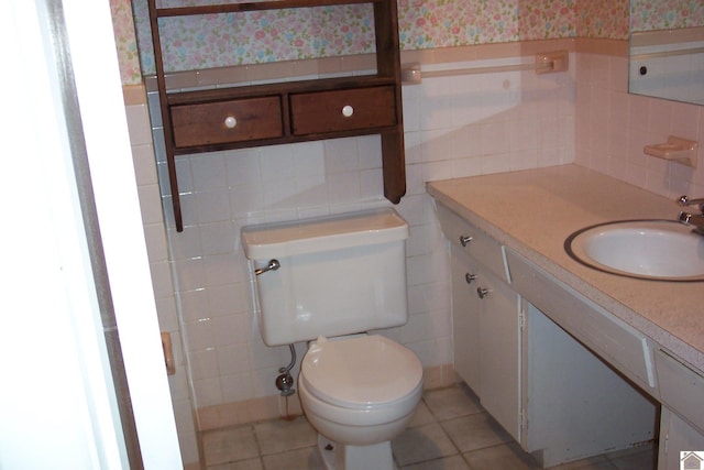 bathroom featuring tile walls, vanity, tile patterned floors, and toilet