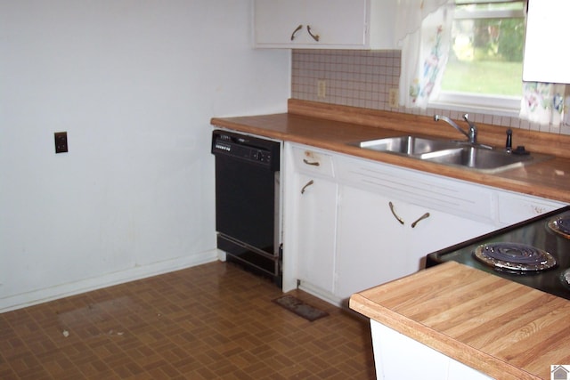 kitchen with tasteful backsplash, white cabinetry, black dishwasher, and sink