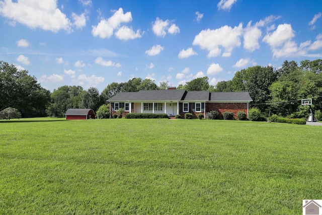 ranch-style house with an outdoor structure and a front yard