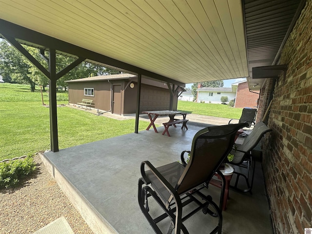 view of patio with an outbuilding and a garage