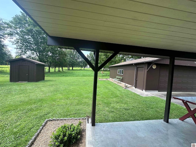 view of yard featuring a garage and a storage unit