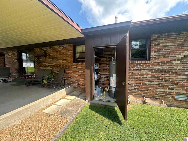 entrance to property with a patio and gas water heater