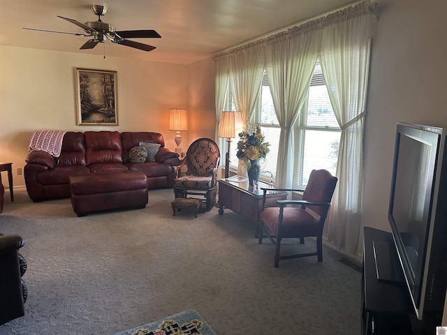 living room with ceiling fan and carpet floors