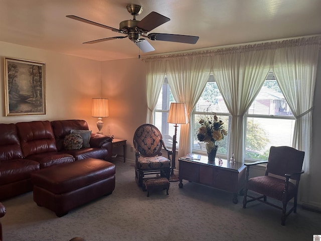 carpeted living room with ceiling fan