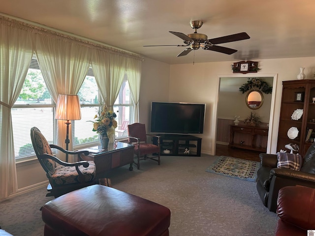 carpeted living room with ceiling fan