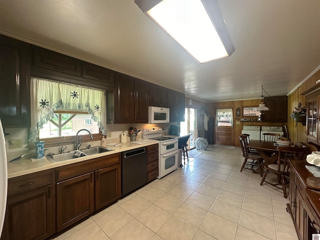 kitchen featuring sink, light tile patterned flooring, a wealth of natural light, and white appliances