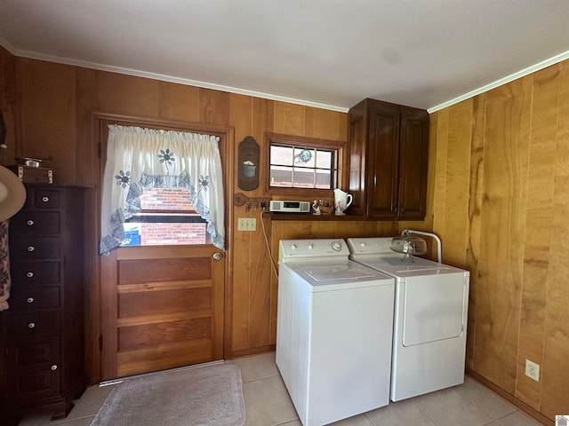 laundry room with separate washer and dryer, cabinets, light tile patterned floors, and wooden walls