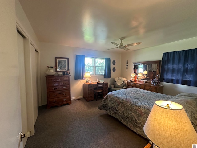 carpeted bedroom featuring ceiling fan and a closet