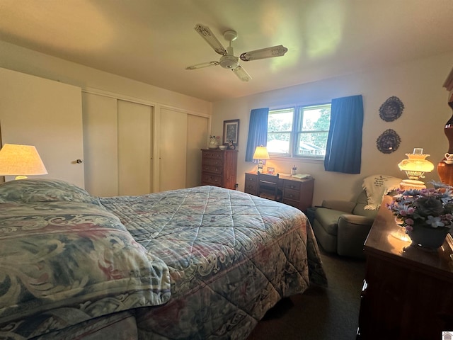 carpeted bedroom featuring multiple closets and ceiling fan