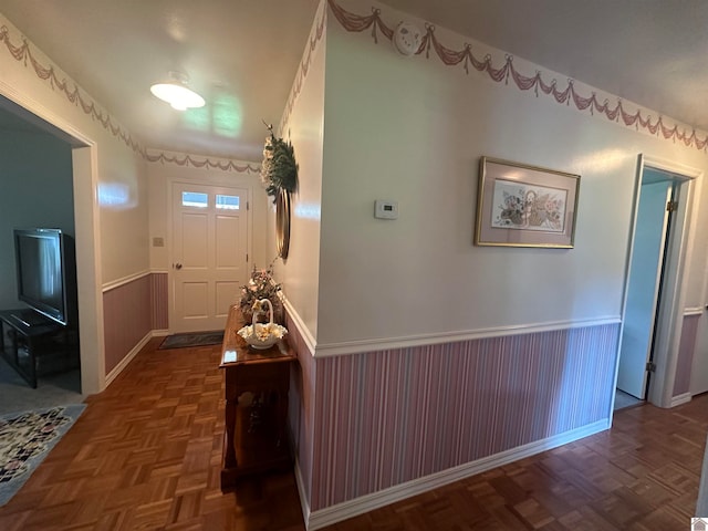 hall featuring dark parquet flooring