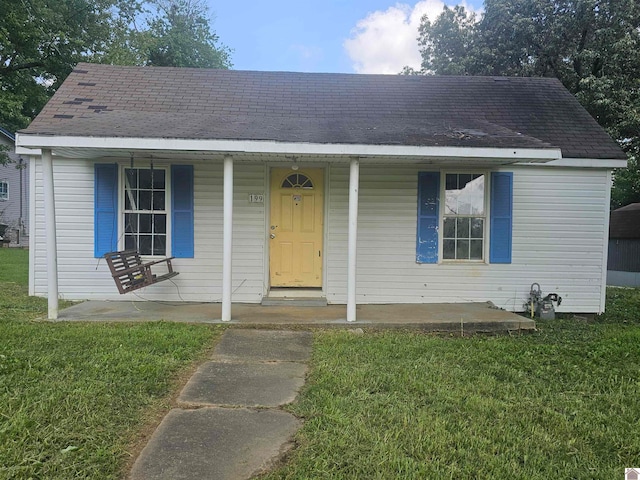 bungalow-style house with a porch and a front lawn