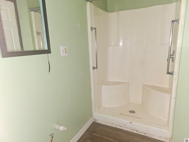 bathroom featuring hardwood / wood-style flooring and a shower