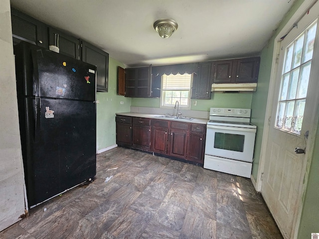 kitchen with white range with electric cooktop, sink, dark tile patterned floors, and black refrigerator