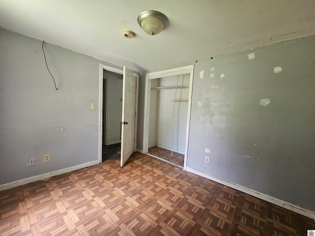 unfurnished bedroom featuring parquet floors