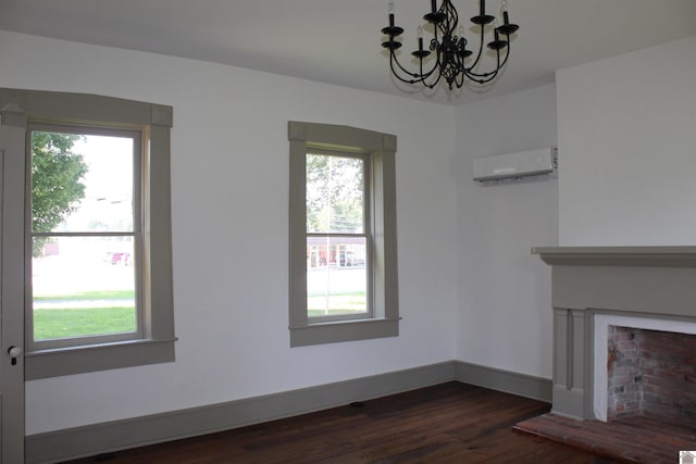 unfurnished living room featuring a notable chandelier, dark hardwood / wood-style flooring, and a wealth of natural light