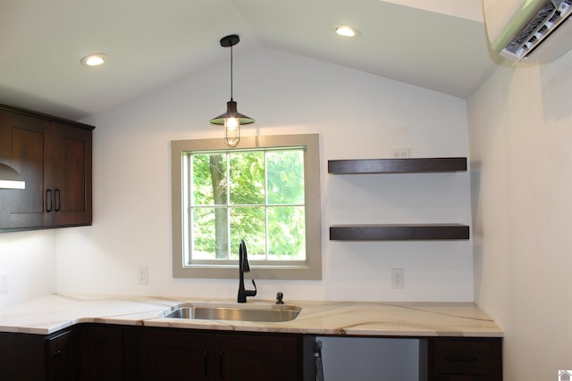 kitchen with hanging light fixtures, light stone countertops, dark brown cabinets, vaulted ceiling, and sink