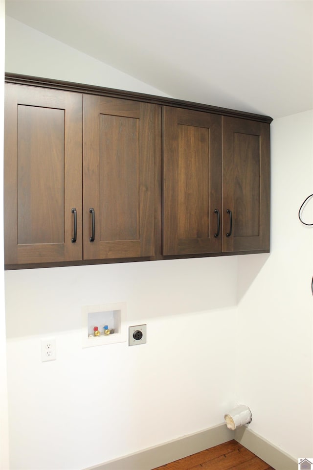 laundry room featuring hardwood / wood-style floors, washer hookup, hookup for an electric dryer, and cabinets