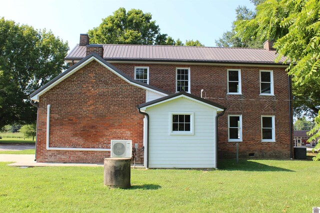 exterior space with cooling unit and a front lawn