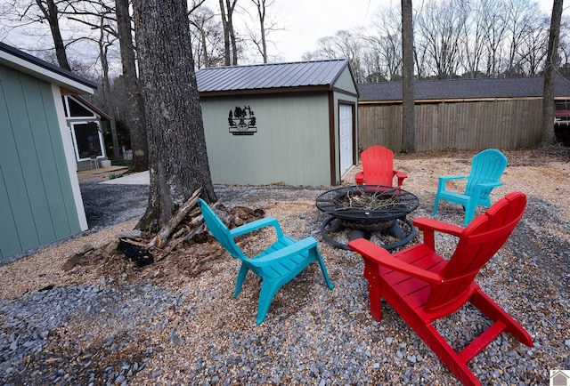 view of patio / terrace with an outdoor structure and a fire pit