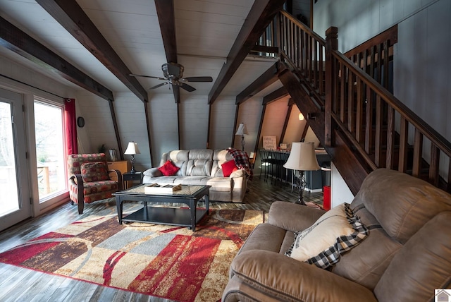 living room with ceiling fan, hardwood / wood-style flooring, and beamed ceiling